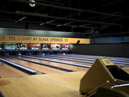 A bowling alley with multiple lanes and a sign for 