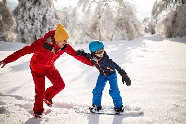 Father and son snowboarding