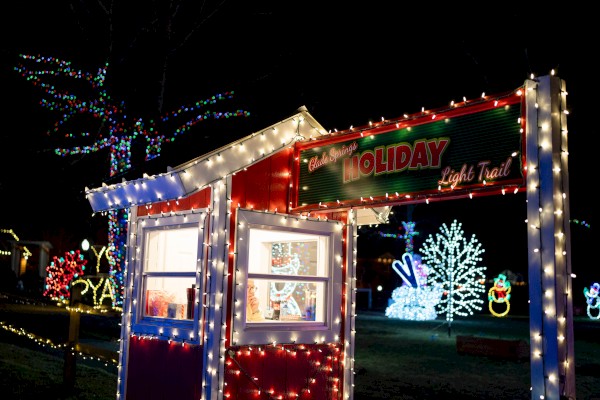 Festive holiday display with colorful lights, signs, and decorations, creating a cheerful and vibrant atmosphere.