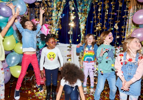 A group of children joyfully playing amid colorful balloons and decorations, with confetti in the air, creating a festive atmosphere.