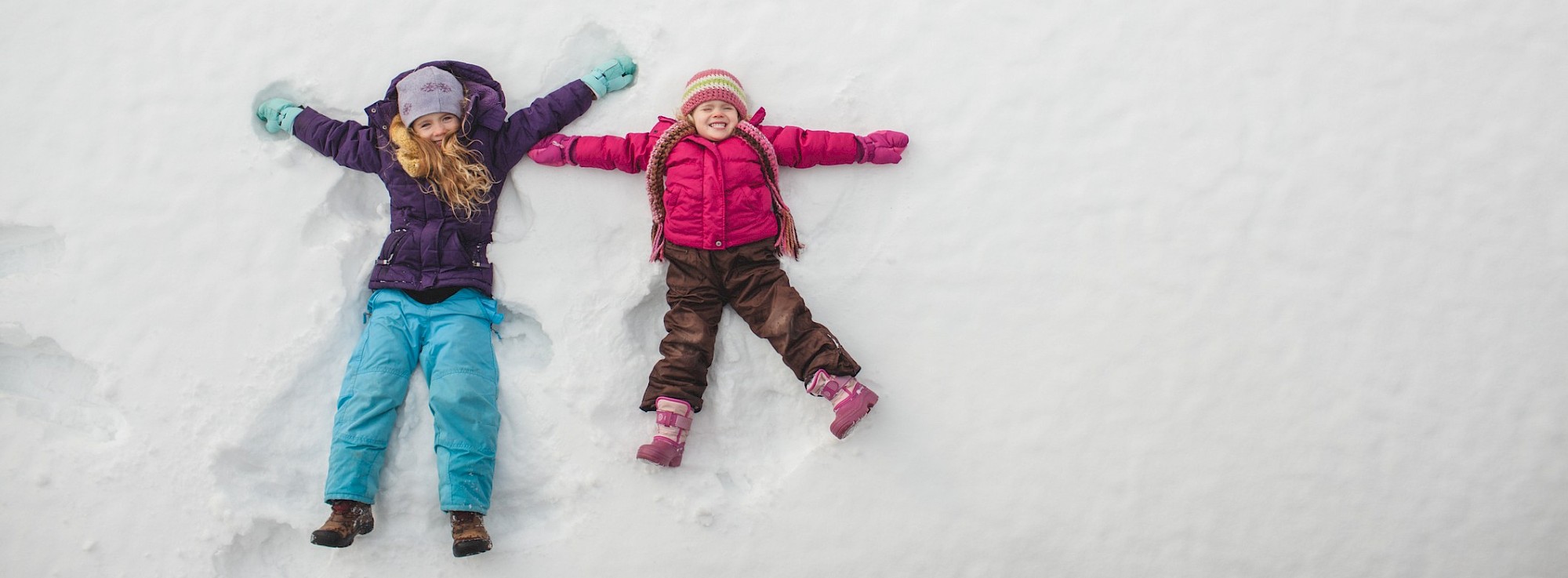 Children laying in snow