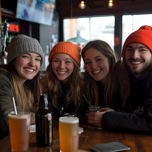 group of friends sitting at table smiling at camera